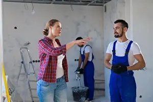 Housework Prints: A woman monitors the renovation process in the apartment and talks to the foreman