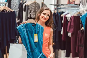 Fashionista Prints: Woman pondering buying a blue dress in fashion store