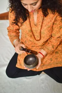 Meditating Prints: A woman practicing meditation and healing with a Tibetan singing bowl