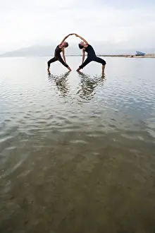 Practising Prints: two woman practise couple yoga in nature