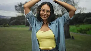 Tank Top Prints: Woman raising arms above head, exposed shoulders and smiling in forest wearing glasses