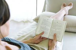Mid Adults Prints: Woman reading, over the shoulder shot