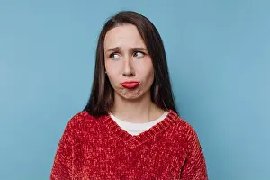 Human Face Prints: Woman in red sweater with a confused expression on blue background