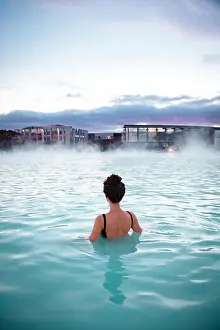 Geothermal Prints: Woman relaxes and enjoys of spa in hot spring Blue Lagoon in Ice