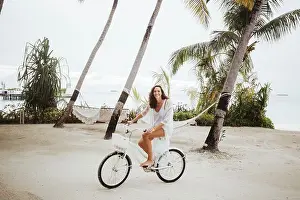 Pleasant Prints: Woman riding bicycle on the beach, Maguhdhuvaa Island, Gaafu Dhaalu Atoll, Maldives