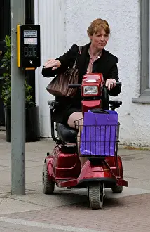 Forties Prints: Woman seated on a Rascal mobility scooter at pedestrian crossing
