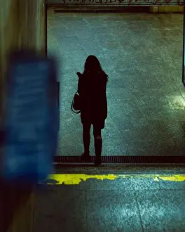 Melancholy Prints: woman seen from behind in the underground passage