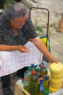 Peasant Prints: Woman selling cheese and olive oil at market in old town section of Zadar Croatia