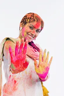 Braids Prints: Woman showing her colored hands on Holi