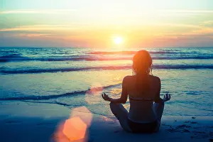 Sand Sea Prints: Woman silhouette yoga on the beach during sunset