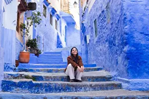 Charm Prints: A woman sits on vibrant blue steps