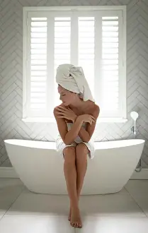 Homey Prints: Woman sitting on the edge of bathtub and embracing self