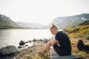 Spare Prints: Woman sitting at lake in mountains