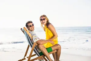 Escapism Prints: Woman sitting on mans lap at beach