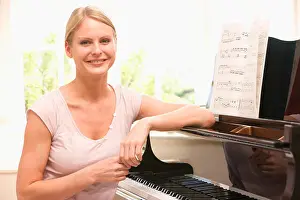 Generation X Prints: Woman sitting at piano and smiling
