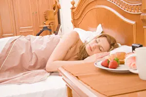 Nightstand Prints: Woman sleeping in bedroom, with the breakfast at nightstand
