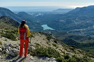 At The Edge Of Prints: A woman standing on a rocky point overlooking Mediterranean sea