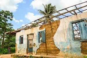 West Africa Prints: Woman standing by the ruins of a house in Sierra Leone, Africa