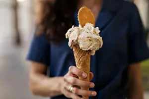 Gelato Prints: Woman standing in the street holding a waffle Cone with Pistachio and Stracciatella gelato