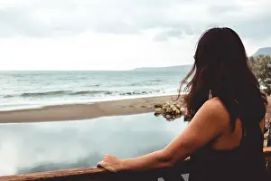Staring Prints: Woman staring at the sea with her back facing the camera