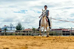Middle Aged Prints: Woman taking horse riding lessons in a paddock