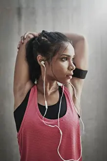 Podcast Prints: Woman, thinking and stretching with music for fitness or training