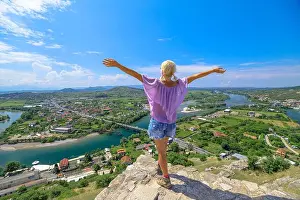 Stronghold Prints: woman tourist embraces the castle's architectural heritage