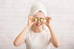 Awake Prints: Woman with towel on head covering eye with cucumber slices