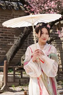 Korean Ethnicity Prints: A woman in a traditional Korean dress poses for pictures at Changgyeonggung Palace in Seoul