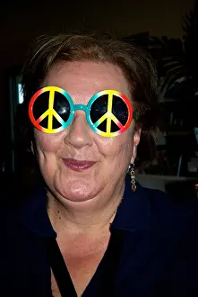 State Park Prints: Woman trying on rainbow peace symbol sunglasses Gulf Shores Alabama State Park pier souvenir shop
