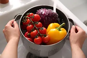Colander Prints: Woman washing fresh vegetables in kitchen sink, closeup