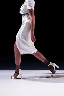 Well Dressed Prints: Woman wearing tweed white jacket and skirt, classic fashion clothing on black background