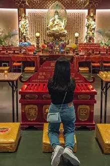 Tooth Prints: Woman worshipping at the Buddha Tooth Relic Temple