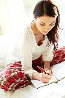 Pajamas Prints: Woman writing letter on bed