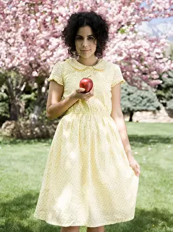 Puerto Prints: woman in a yellow dress with a red apple