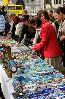 Customers Prints: Women buying jewllery from a Dublin market southern Ireland