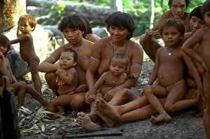 Infant Prints: Women and children of the Yanomami tribe sit together on the ground