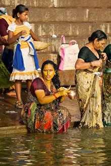 Varanasi Prints: Women come to bathe and pray in the holy waters of the Ganges River in the Hindu city of Varanasi