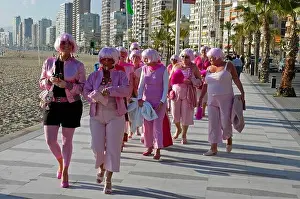 Coastal Area Prints: Women in pink clothes, promenade, Benidorm, Costa Blanca, Spain