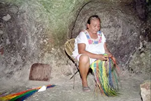 Weave Prints: A women weaves a straw hat She works in a cave to escape the heat and humidity Becal Campeche Mexico