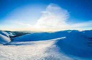Hill Glacier Prints: Wonderful day panorama of snowdrifts in the mountains among the forests on a sunny frosty foggy day