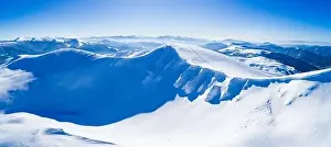 Wonderful giant snowdrifts on the hills in the mountains covered in snow on a sunny frosty winter day