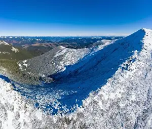 Wonderful landscapes covered with the first snow with large rocky ledges of the Carpathian Mountains