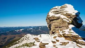 Wonderful landscapes covered with the first snow with large rocky ledges of the Carpathian Mountains