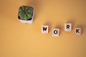 Begin Prints: wood cube block text work on yellow background.copy space