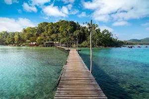 Sea Island Prints: Wooden boat pier in sea and hut with clear day sky in Koh Mak at Trat