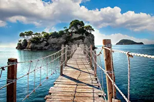 Agios Prints: The wooden bridge overlooking the sea leads to an island with palm trees