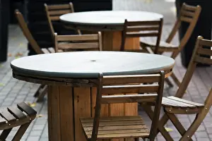 Tables Prints: wooden chairs close-up in a street cafe