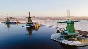 Wooden historical windmills Zaanse Schans windmill village during winter with snow