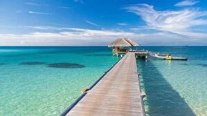 Images Dated 11th December 2015: Wooden jetty over the beautiful Maldivian sea with blue sky. tranquil travel landscape, seascape